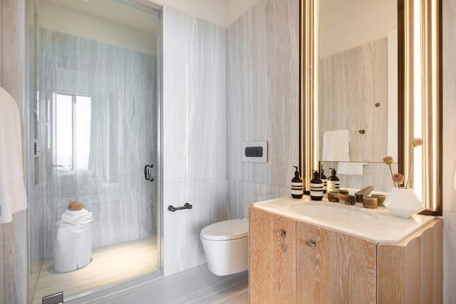 bathroom featuring vanity, tile walls, toilet, and a stall shower