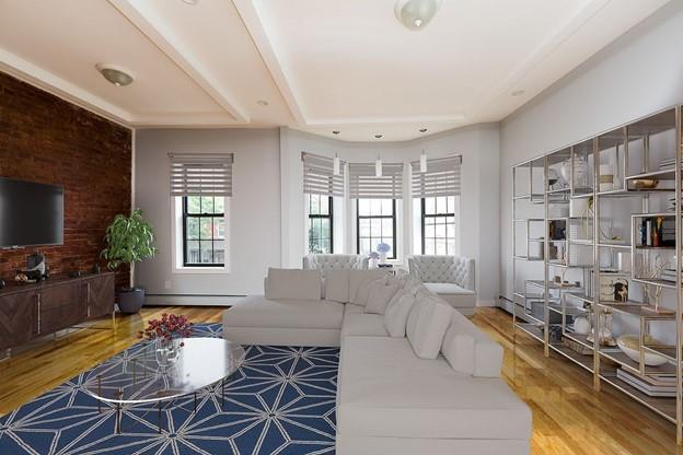 living area featuring a baseboard radiator and wood finished floors