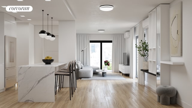 interior space featuring light stone counters, light hardwood / wood-style flooring, white cabinets, and hanging light fixtures