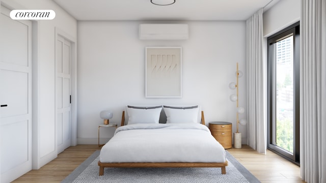 bedroom with light wood-type flooring and a wall mounted AC