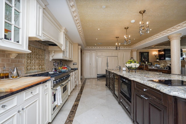 kitchen with decorative light fixtures, backsplash, wooden counters, dark brown cabinetry, and black appliances