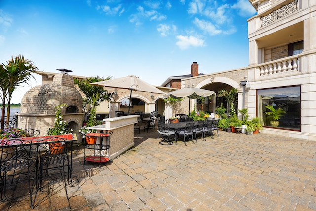 view of patio featuring outdoor dining space and a fireplace