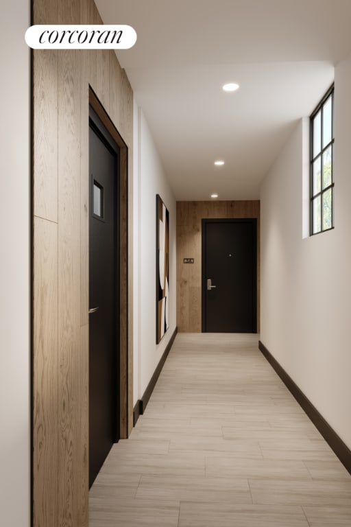 corridor with light hardwood / wood-style flooring