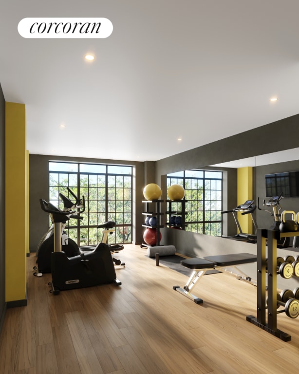 gym with hardwood / wood-style flooring and floor to ceiling windows