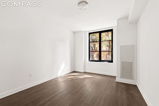 empty room with dark hardwood / wood-style floors