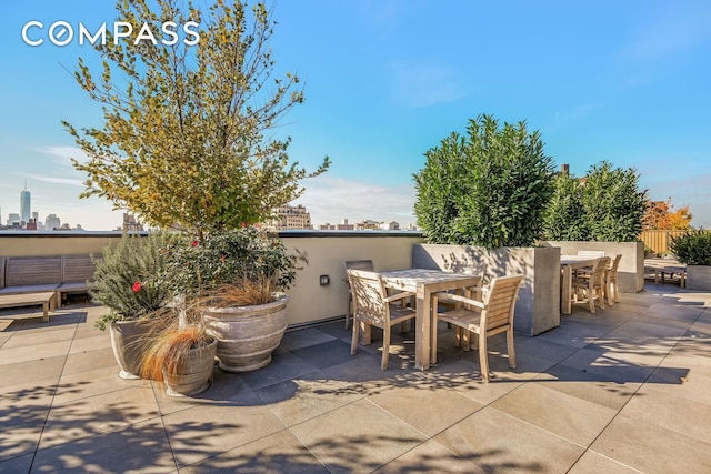 view of patio / terrace with a view of city and outdoor dining area