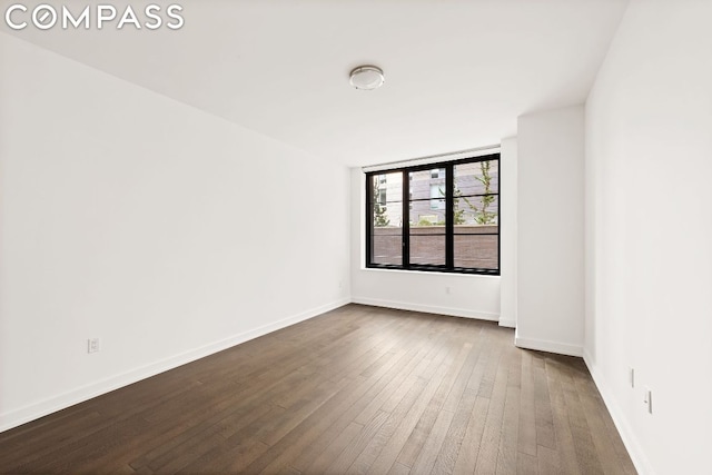 unfurnished room with dark hardwood / wood-style floors