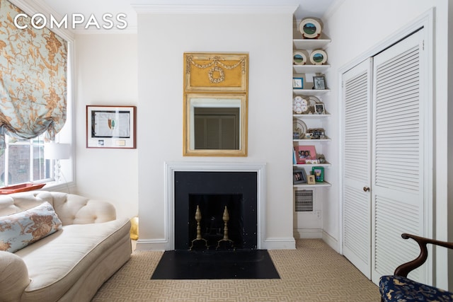 living room featuring a fireplace with flush hearth, carpet flooring, baseboards, and ornamental molding