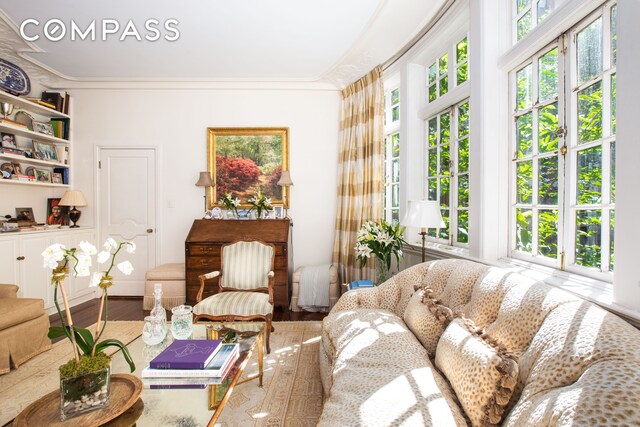 interior space with hardwood / wood-style flooring and ornamental molding