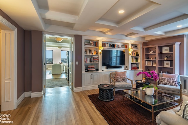 living room with beam ceiling, coffered ceiling, light hardwood / wood-style floors, and built in shelves