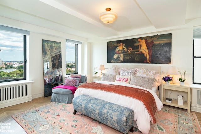 bedroom featuring radiator and light parquet floors