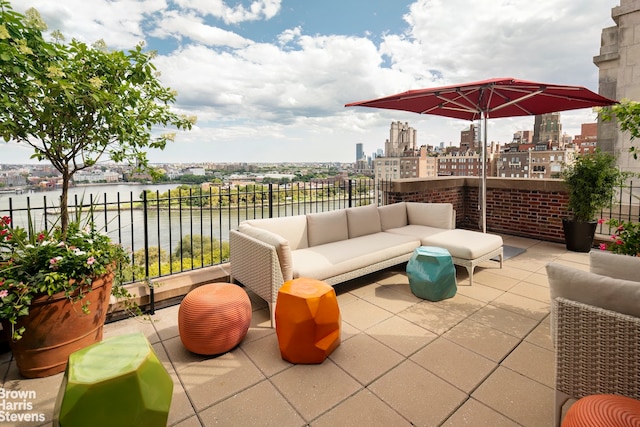 view of patio with an outdoor living space and a water view