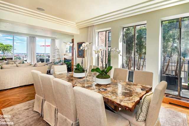 dining area featuring ornamental molding and parquet floors