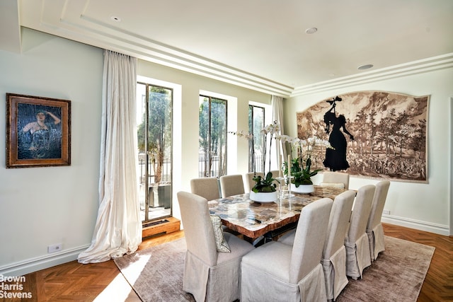 dining space featuring ornamental molding and parquet floors