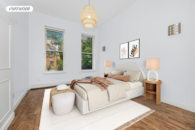 bedroom with wood-type flooring and a baseboard radiator