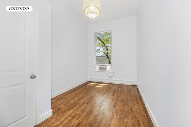 spare room with dark hardwood / wood-style flooring and cooling unit