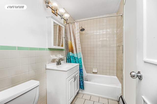 full bathroom featuring tile walls, shower / bath combination with curtain, tile patterned flooring, vanity, and toilet