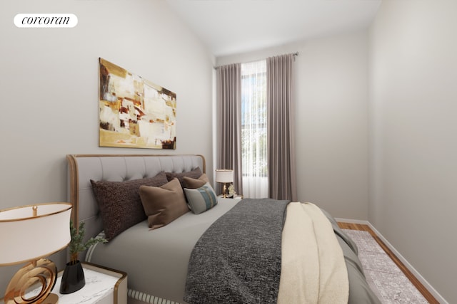 bedroom with hardwood / wood-style flooring and vaulted ceiling