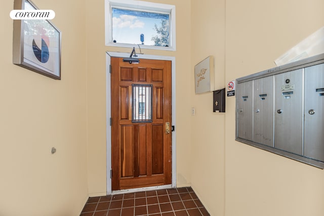 entrance foyer featuring a towering ceiling and mail boxes