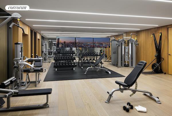 workout area with wooden walls and light hardwood / wood-style floors