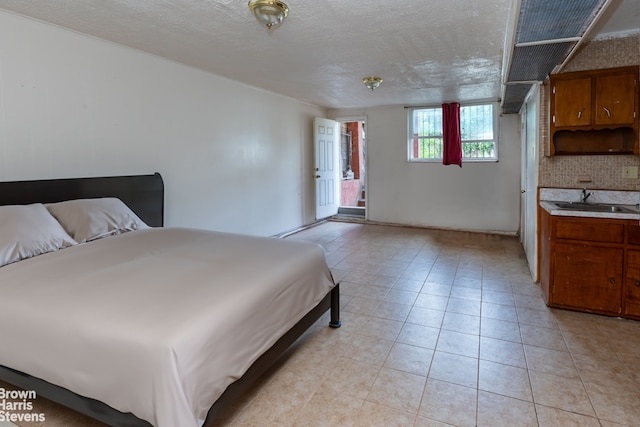 bedroom with sink and a textured ceiling