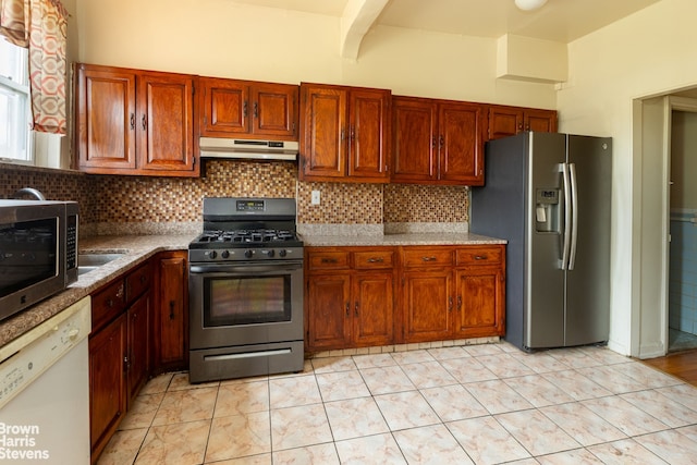 kitchen with stainless steel appliances, tasteful backsplash, light tile patterned floors, and light stone counters