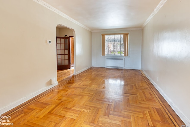 unfurnished room with ornamental molding, light parquet flooring, and radiator