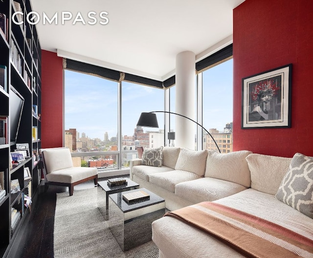 living room with hardwood / wood-style flooring, expansive windows, and a wealth of natural light