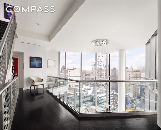 hallway featuring floor to ceiling windows and dark hardwood / wood-style floors