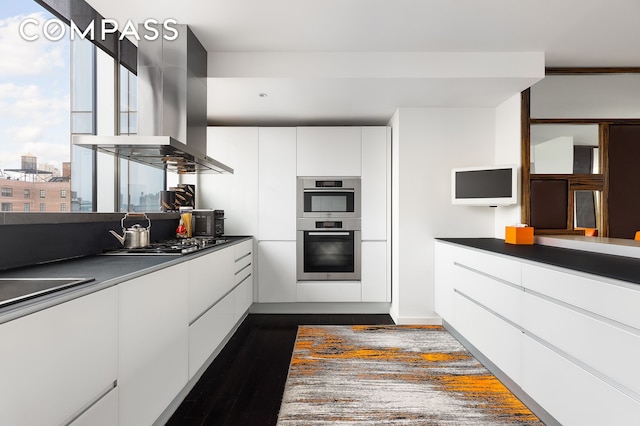 kitchen with white cabinetry, double oven, range hood, modern cabinets, and gas cooktop