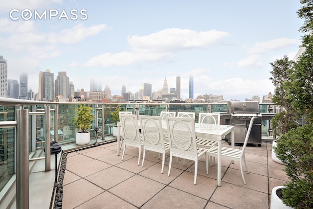 exterior space featuring a grill, a view of city, and a balcony