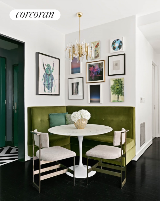 dining area with breakfast area, a chandelier, visible vents, and wood finished floors