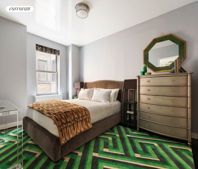 bedroom featuring dark colored carpet and visible vents