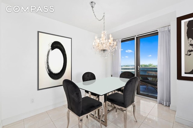 dining area featuring light tile patterned floors, baseboards, and a chandelier