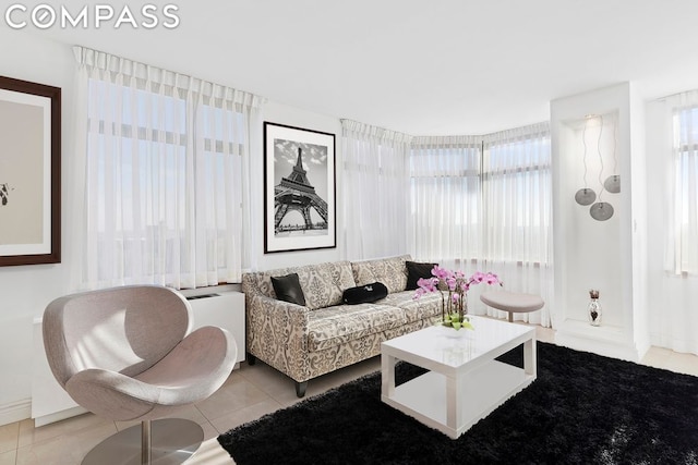 living room with plenty of natural light and light tile patterned floors