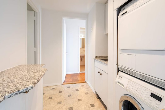 laundry room featuring stacked washer / dryer