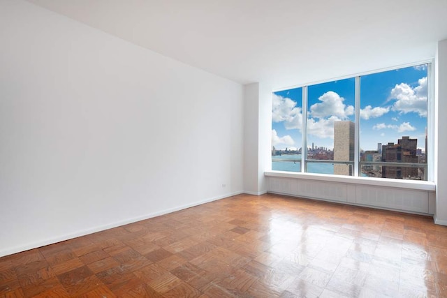 empty room with a water view and parquet flooring