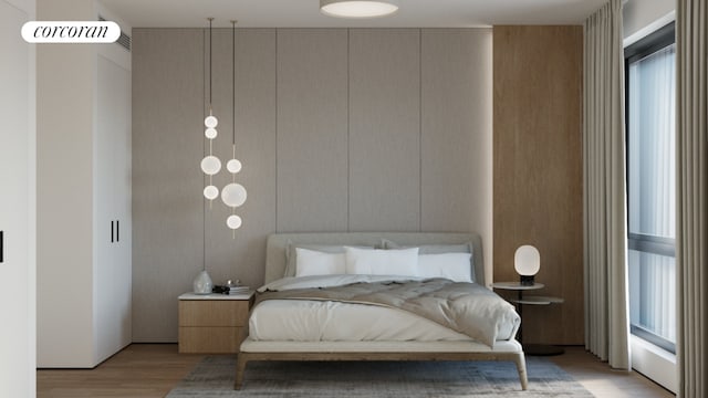 bedroom featuring multiple windows and light hardwood / wood-style flooring