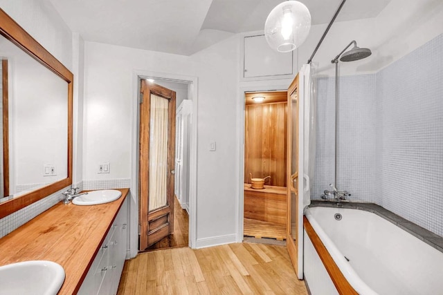 bathroom with vanity, wood-type flooring, and shower / bathtub combination with curtain