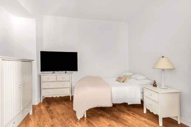 bedroom with hardwood / wood-style flooring