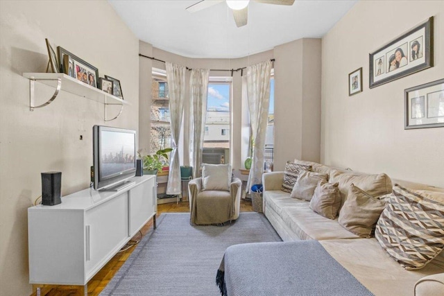 living room featuring hardwood / wood-style floors and ceiling fan