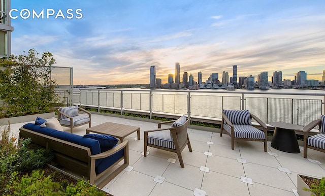 view of patio / terrace with an outdoor living space and a city view