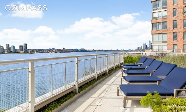 balcony with a water view and a city view