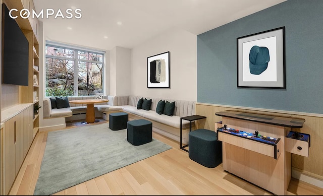 interior space featuring a wainscoted wall and wood finished floors