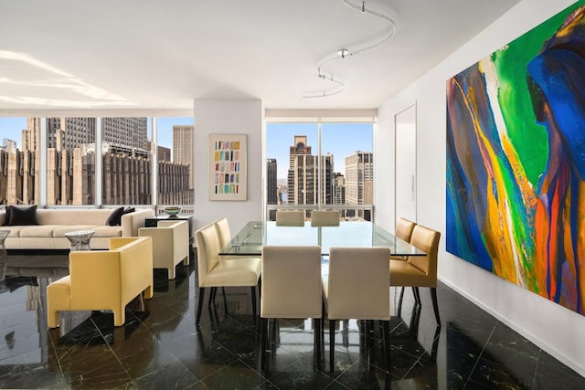 dining area featuring baseboards and a city view