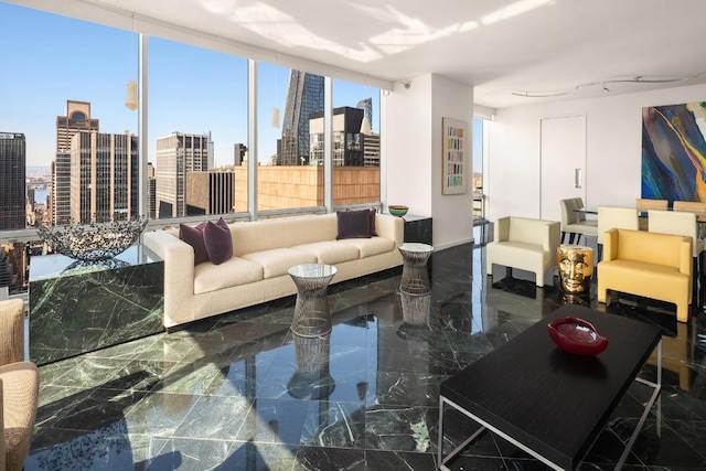 living area featuring marble finish floor, a view of city, and a wall of windows