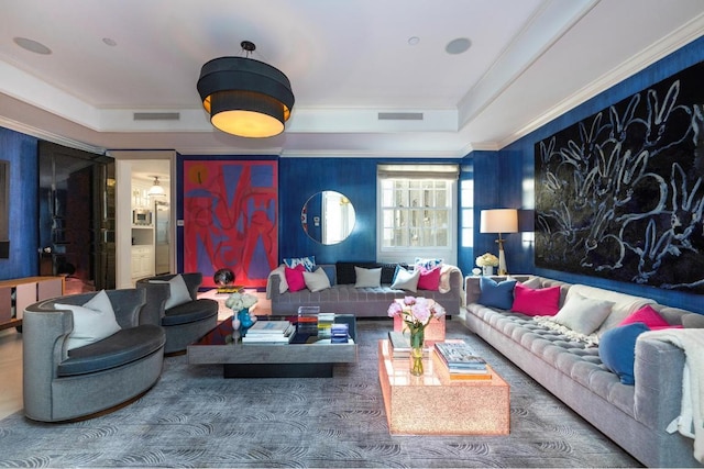 living room featuring crown molding and a tray ceiling