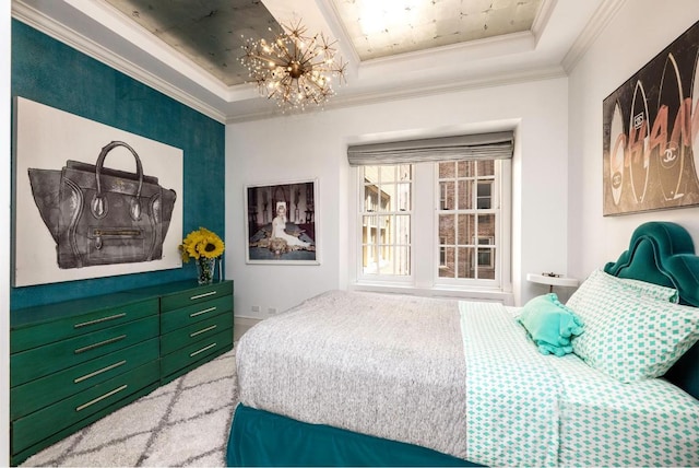 bedroom featuring a notable chandelier, a tray ceiling, and ornamental molding