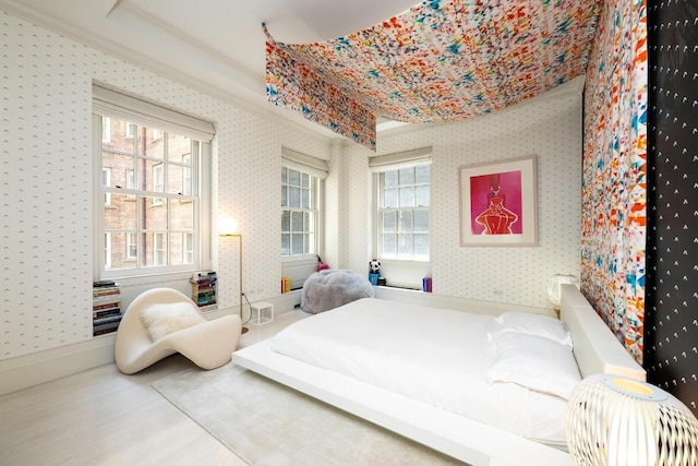 bedroom featuring multiple windows and hardwood / wood-style floors