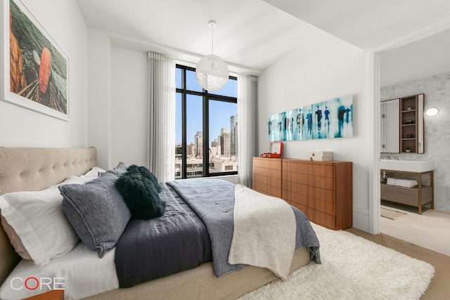 bedroom featuring wood-type flooring and access to outside